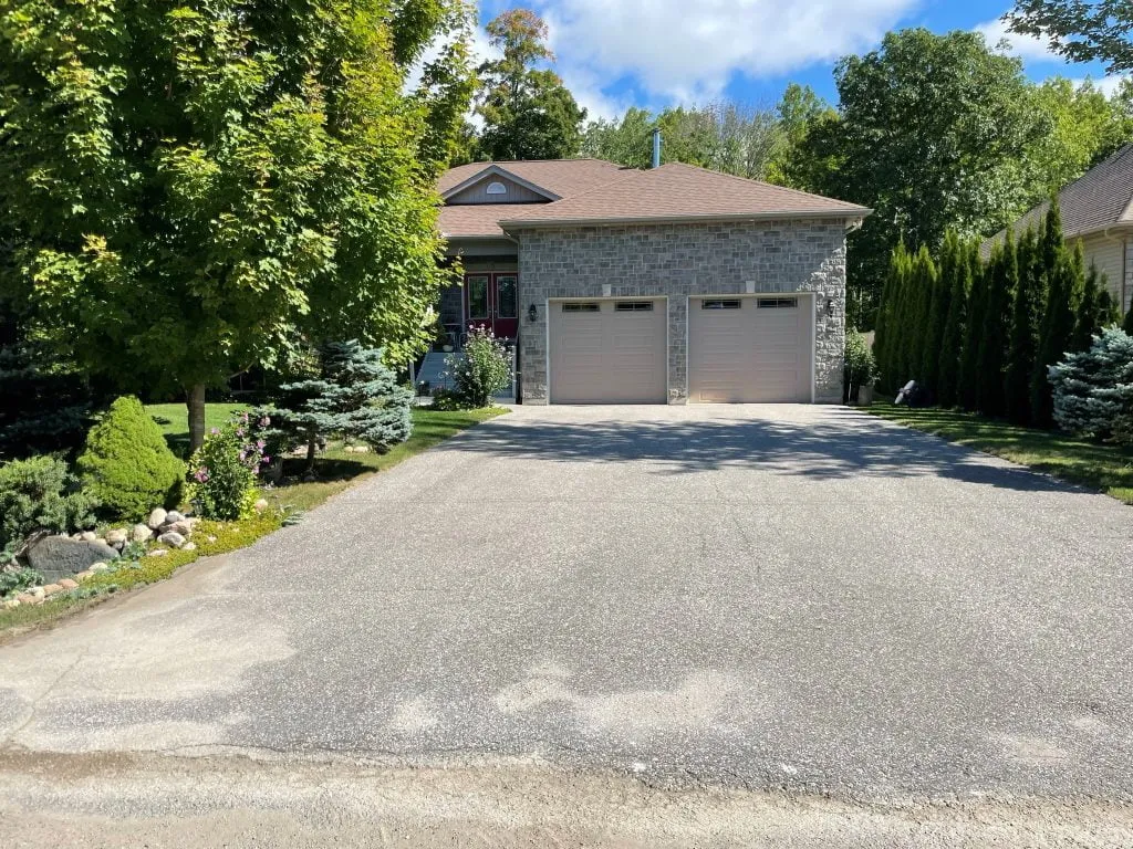 Before sealcoating: full driveway sealcoating with clean, crisp edges in Tiny Township, Ontario