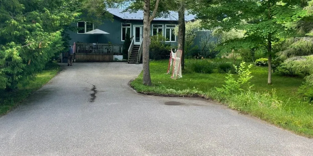Before sealcoating: faded asphalt driveway restored and protected in Tiny Township, Ontario