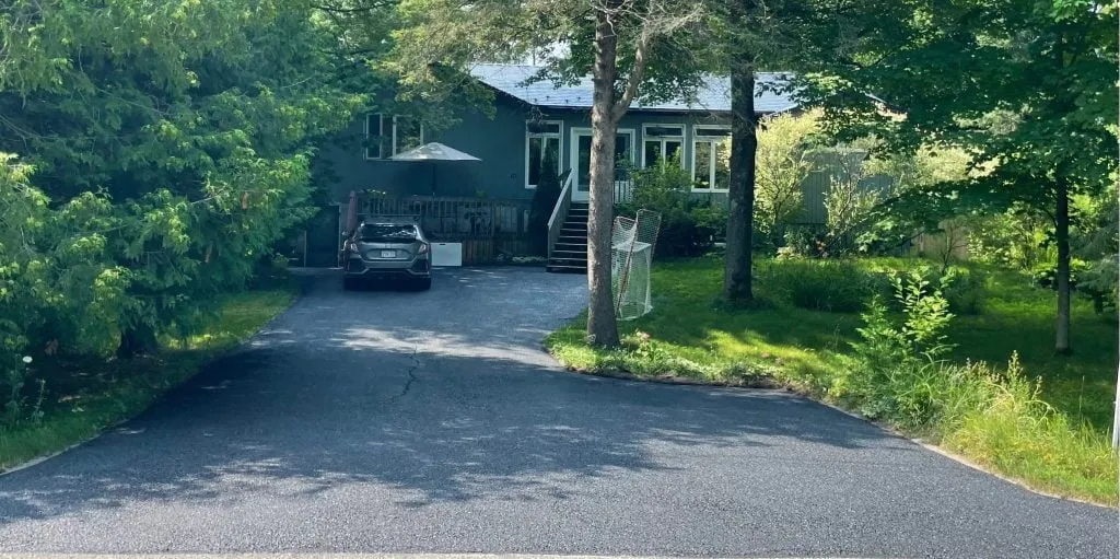 After sealcoating: faded asphalt driveway restored and protected in Tiny Township, Ontario