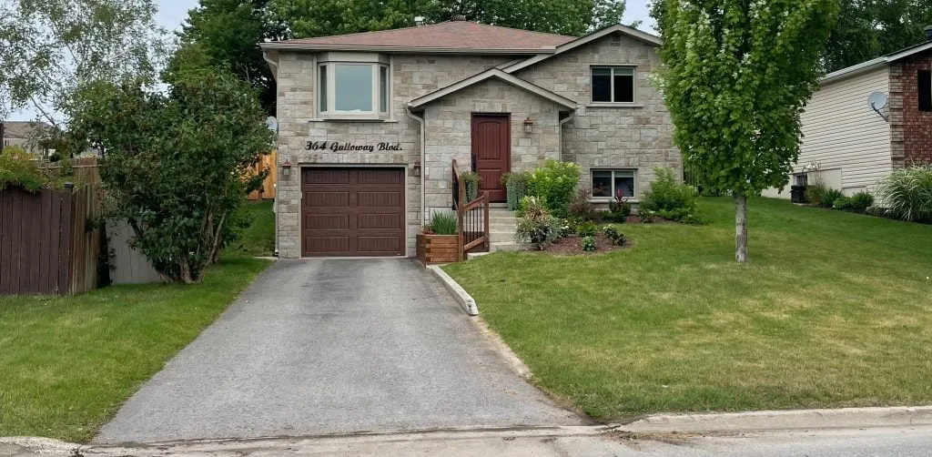 Driveway before sealcoating, faded and weathered asphalt in Midland