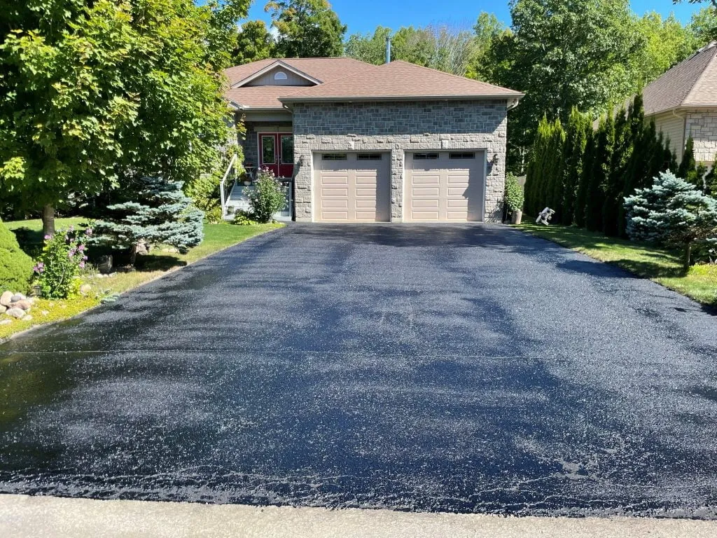 Freshly sealed asphalt driveway with a deep black finish in Simcoe County